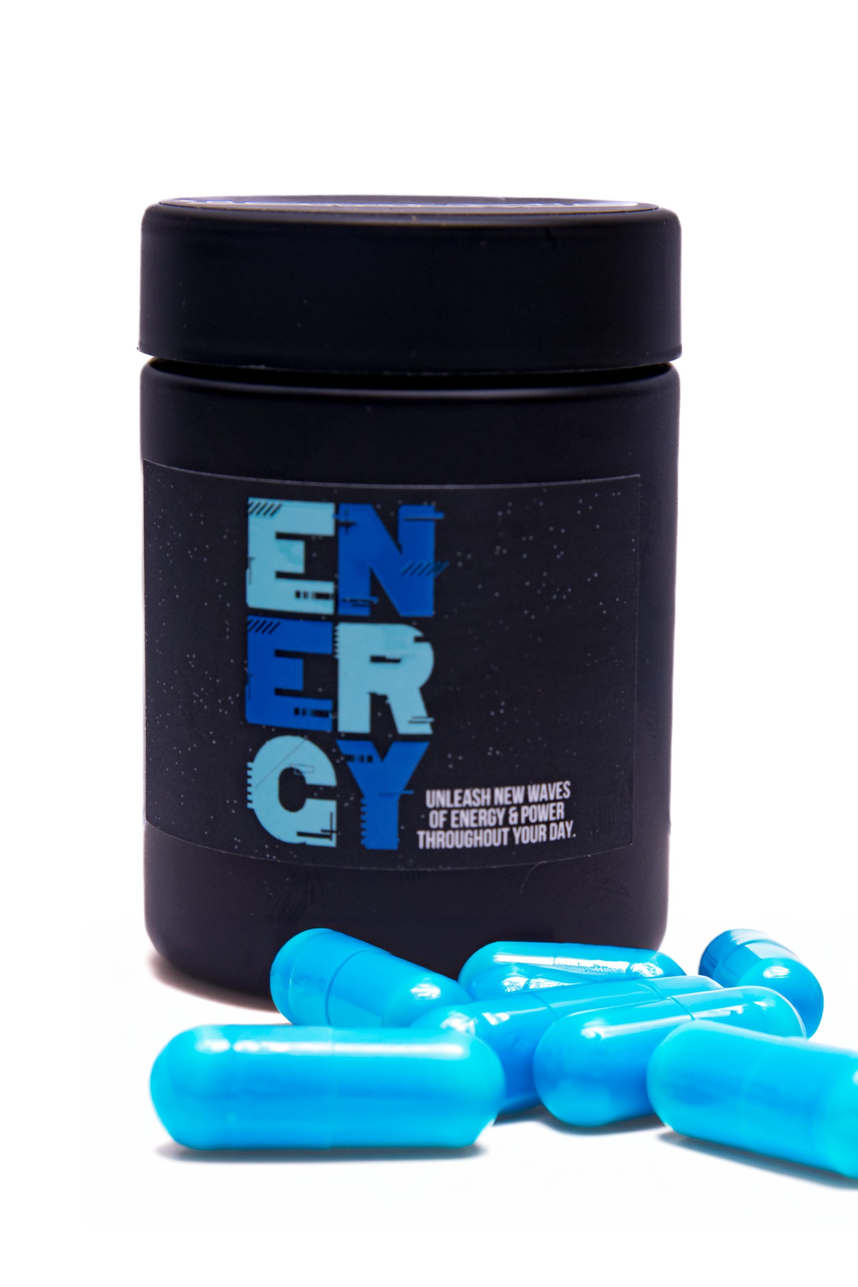 StarDust Energy Wellness Supplement in a bottle with pills underneath it